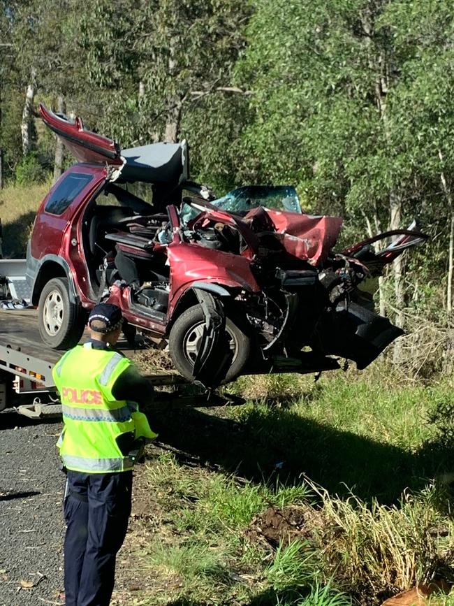 The crumpled car getting lifted on to a tow truck.