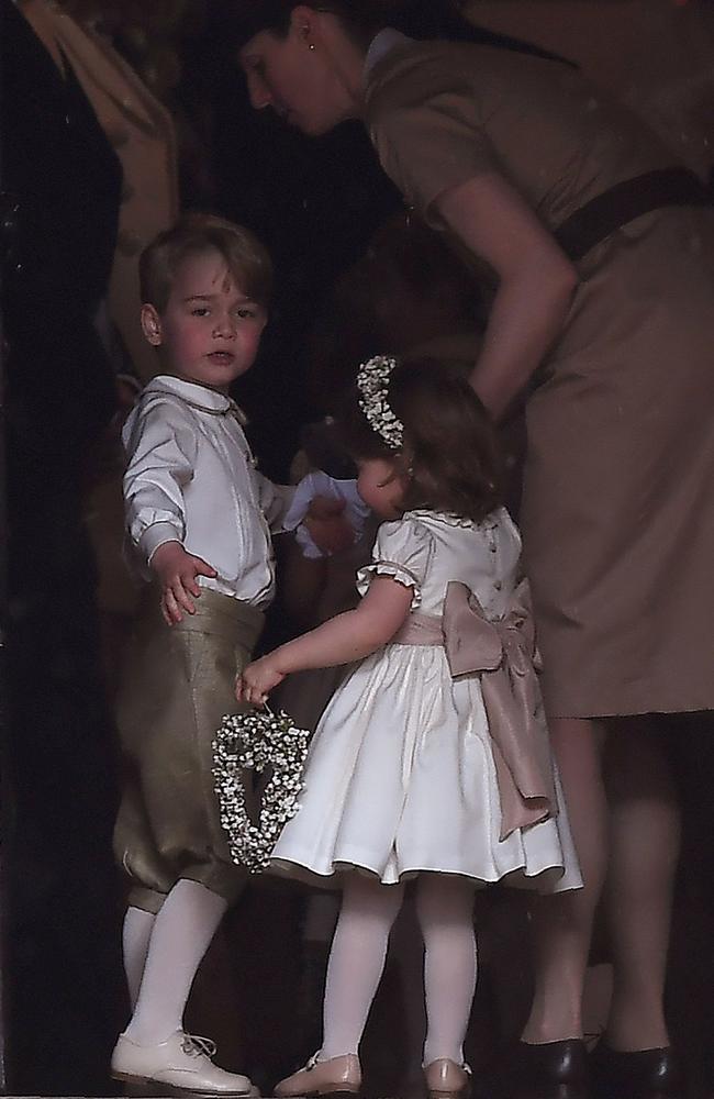 Helping Prince George and Princess Charlotte — page boy and bridesmaid — at Pippa Middleton’s wedding in 2017. Picture: AFP 