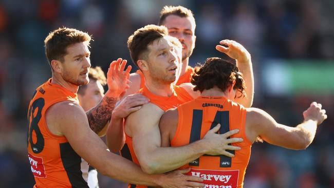 Toby Greene of the Giants celebrates a goal with teammates. Picture: Mark Nolan/AFL Photos/via Getty Images