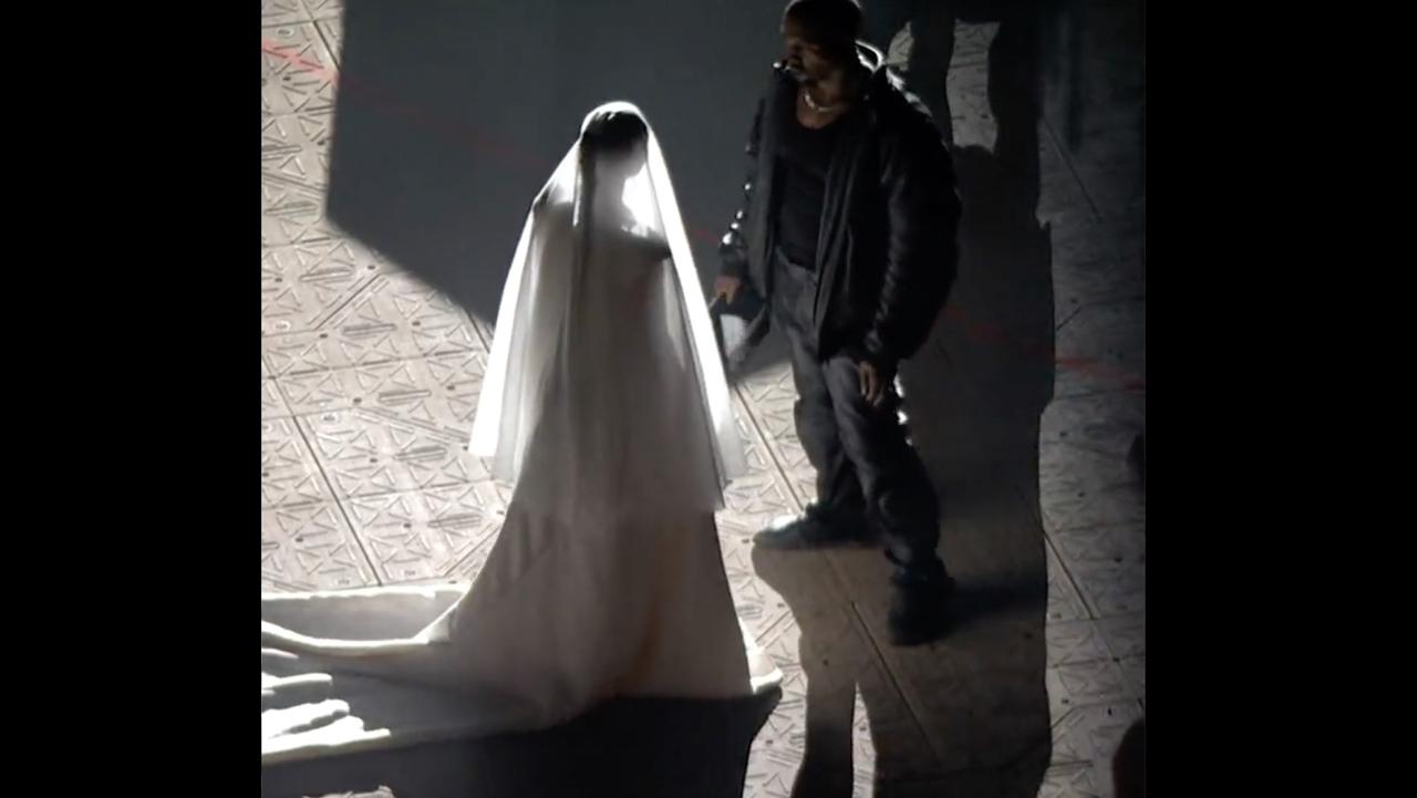 Kim Kardashian, wearing a wedding dress, appeared to restage her wedding to Kanye West in a bizarre appearance, after they had broken up. Picture: Apple Music