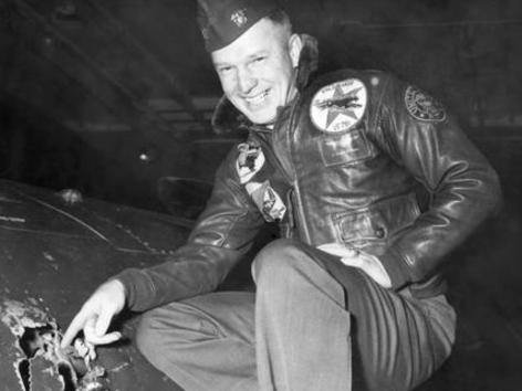 Lt. Royce Williams, USN, points out battle damage to F9F-5 Panther aboard USS Oriskany on 18 Nove