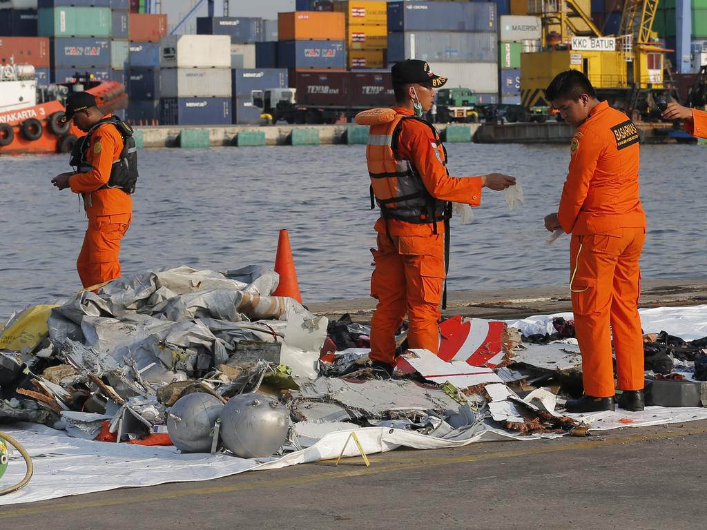 Indonesian Search and Rescue Agency (BASARNAS) inspect debris recovered from near the waters where a Lion Air passenger jet crashed. Picture: AP