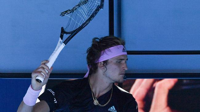 Germany's Alexander Zverev holds up the racquet he just smashed 