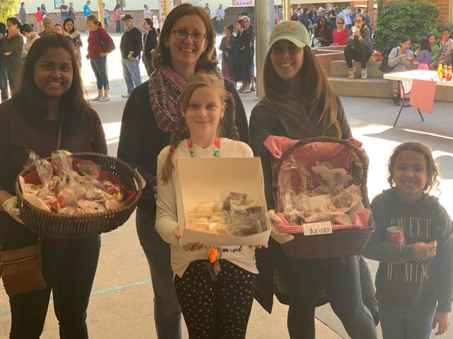 Photo of some volunteers at their cake stall.