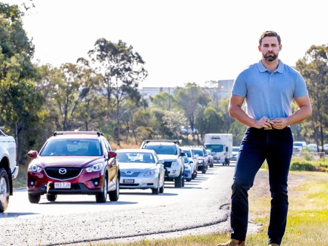 Division One Gold Coast City Council candidate Mark Hammel on the busy Eastern Service Road at Ormeau.