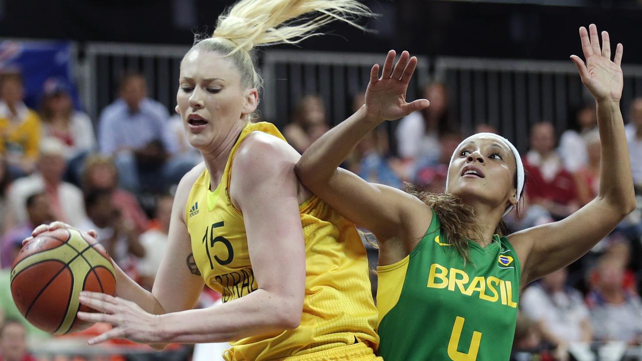 Australia's Lauren Jackson, left, drives to the basket against Brazil's Adriana Pinto during a women's basketball game at the 2012 Summer Olympics in London, UK. Picture: AP