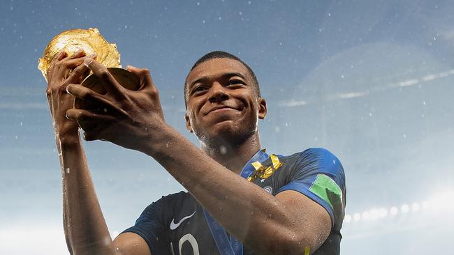 MOSCOW, RUSSIA - JULY 15:  Kylian Mbappe of France celebrates with the World Cup Trophy following his sides victory in the 2018 FIFA World Cup Final between France and Croatia at Luzhniki Stadium on July 15, 2018 in Moscow, Russia.  (Photo by Matthias Hangst/Getty Images)