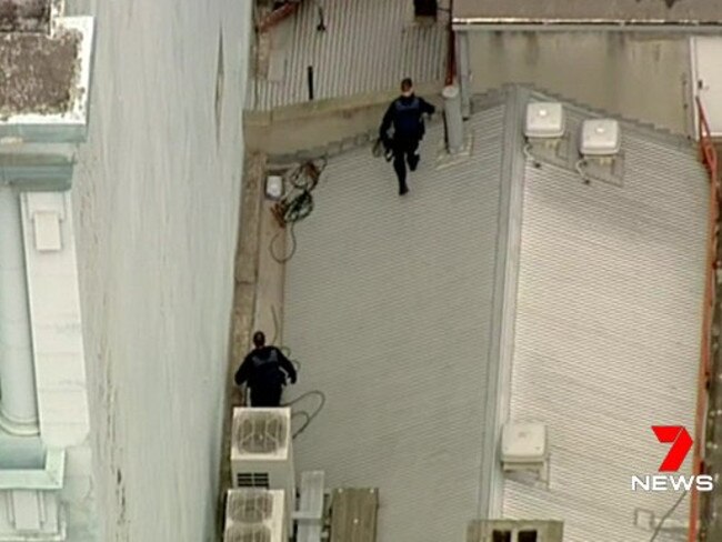 Police search for a burglar on a Melbourne CBD roof. Picture: Channel 7