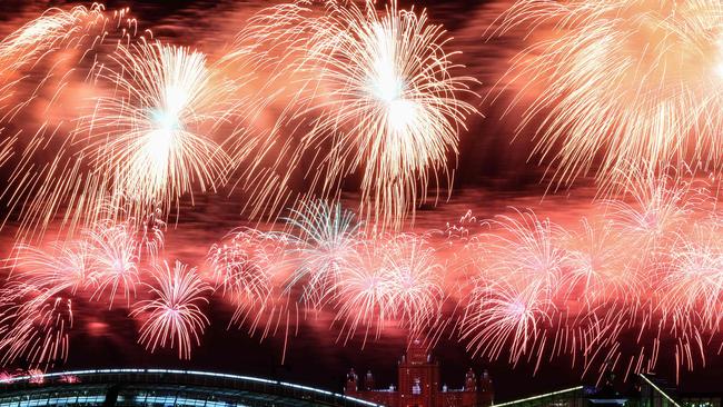 Fireworks explode above a city. (Photo by STRINGER / AFP)
