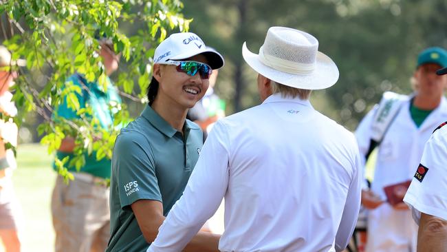 Norman talking with Australia’s Min Woo Lee in the crowd. (Photo by David Cannon/Getty Images)