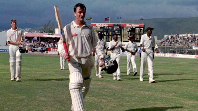 Steve Waugh raises his bat as he leaves the field with teammate Glenn McGrath after his double century in the fourth Test in Kingston, Jamaica in 1995. Picture: AP