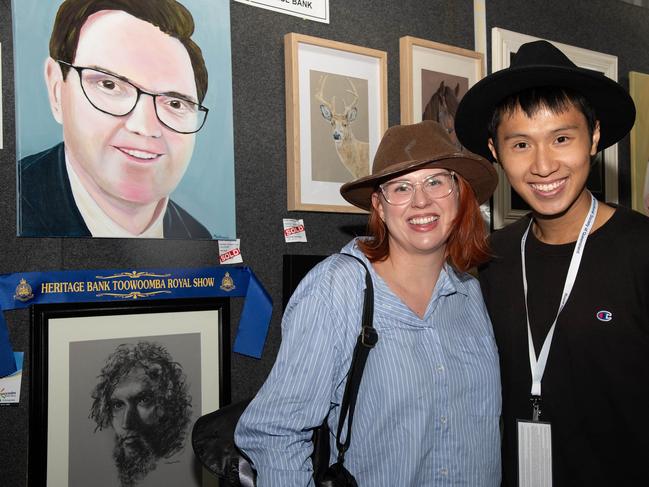 Enjoying the art entries are Amy Clark and Prince Long Lo at the Heritage Bank Toowoomba Royal Show.Saturday April 20th, 2024 Picture: Bev Lacey