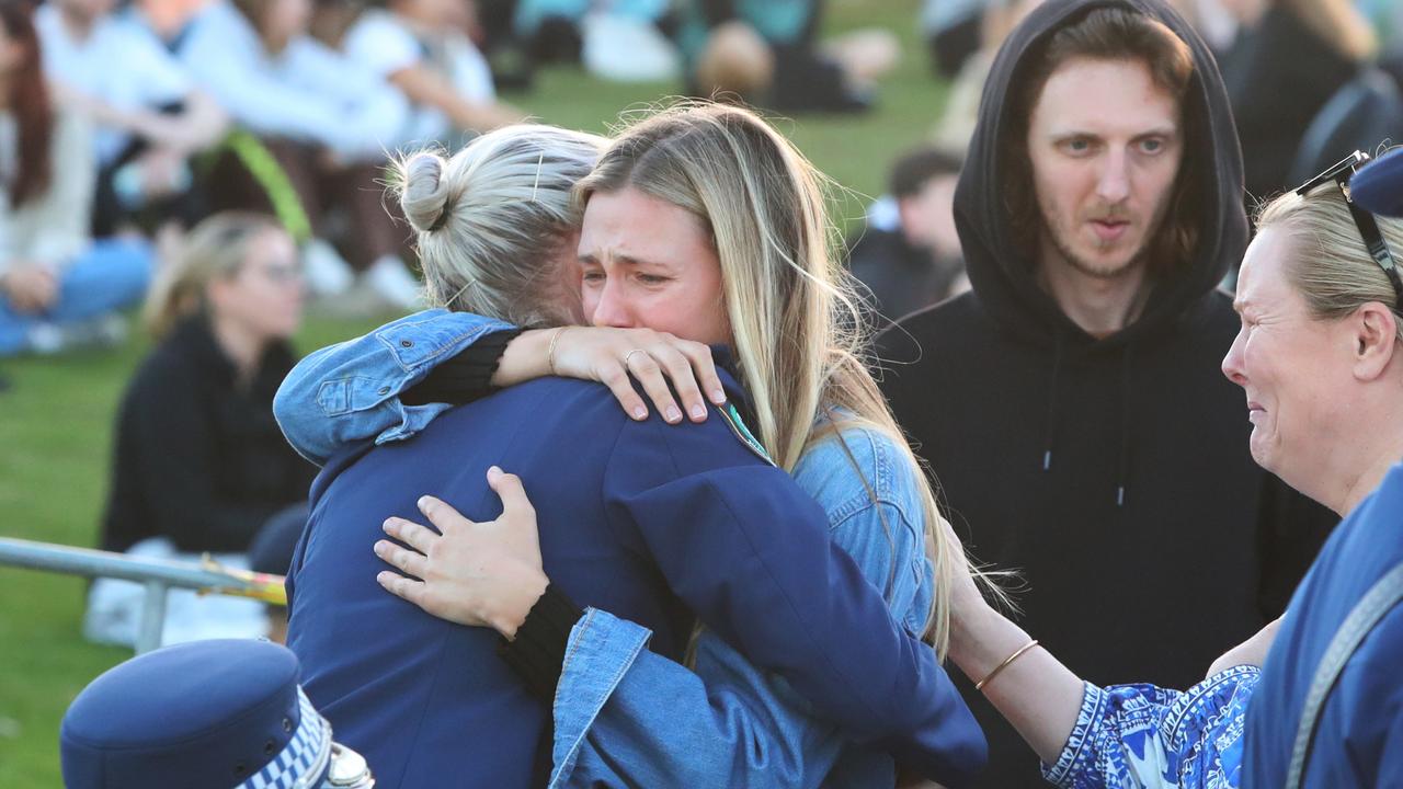 Inspector Scott was embraced by a member of the community at the vigil. Picture: Maree Williams/Getty Images