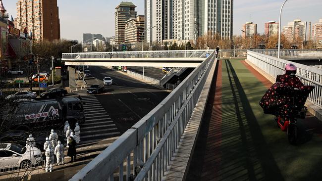 Workers wearing personal protective equipment (PPE) near a residential community that just opened after a lockdown due to Covid-19 restrictions in Beijing earlier this month. Picture: AFP