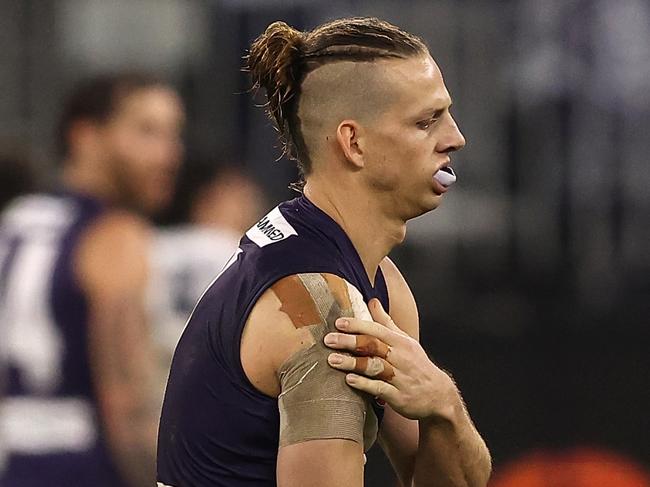 PERTH, AUSTRALIA - JULY 15: Nat Fyfe of the Dockers holds his injured shoulder during the round 18 AFL match between the Fremantle Dockers and Geelong Cats at Optus Stadium on July 15, 2021 in Perth, Australia. (Photo by Paul Kane/Getty Images)