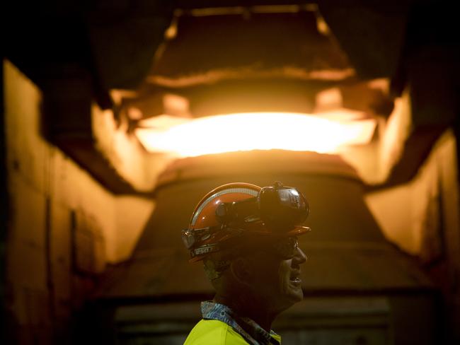 An employee in front of a steel furnace at BlueScope Steel Ltd. Port Kembla steelworks in Port Kembla, Australia, on Friday, Feb. 9, 2024. The world's two biggest miners, BHP Group Ltd. and Rio Tinto Group, are teaming up in a bid to develop Australia's first electric-smelting furnace, in what could prove an important step toward slashing emissions in the steel-making process. Photographer: Brent Lewin/Bloomberg