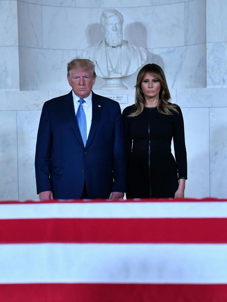 US President Donald Trump and First Lady Melania Trump pay their respects before the flag-draped casket of late Supreme Court Justice John Paul Stevens in the Great Hall of the Supreme Court in Washington. Picture: AFP