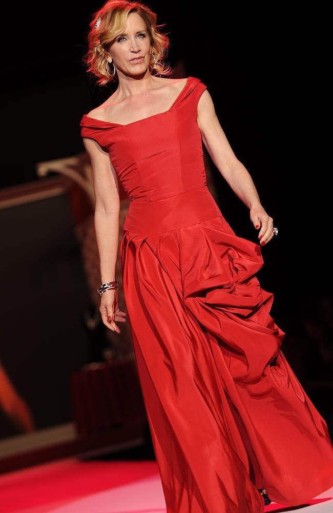 Actress Felicity Huffman models an Oscar De La Renta design from The Heart Truth Red Dress collection. Picture: AP Photo/Stephen Chernin