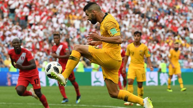 Australia's Aziz Behich looks to cross to Tim Cahill during their final FIFA World Cup group match against Peru. Picture: AAP Image/Dean Lewins