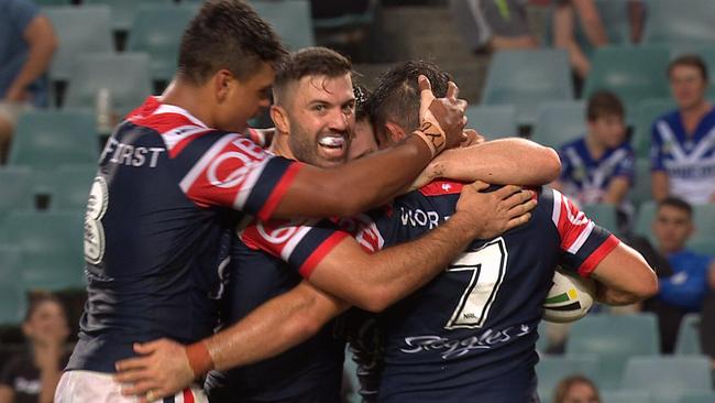 Roosters celebrate a Cooper Cronk try.