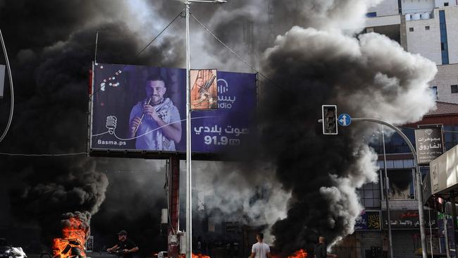 Palestinian youths burn tyres during confrontations with Israeli forces in the occupied West Bank city of Jenin.