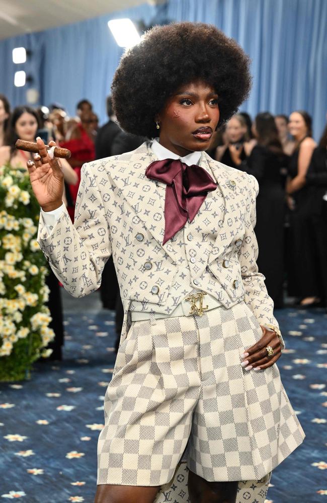 She wore an outfit designed by Pharrell and Louis Vuitton, and pretended to puff on a cigar while there. Picture: Angela WEISS / AFP
