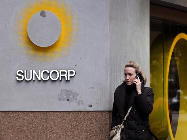 A pedestrian walks past a Suncorp Bank branch in Melbourne on July 18, 2022. - Australian banking giant ANZ announced on July 18 a 3.3 billion USD deal to swallow regional lender Suncorp Bank -- one of the biggest takeovers in the sector for more than a decade. (Photo by William WEST / AFP)