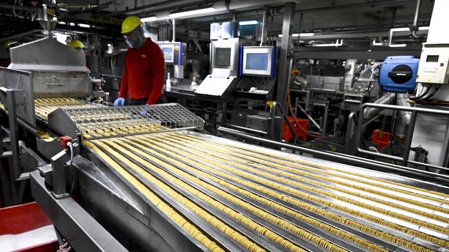 An employee works at the production site of the Pringles potato chips.