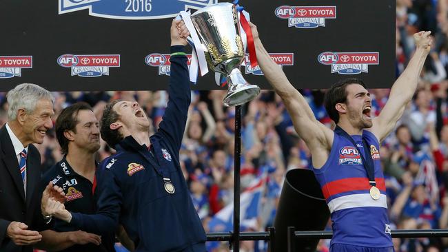 Bob Murphy joins acting captain Easton Wood and coach Luke Beverisge on 2016 AFL Grand Final premiership dais. Picture: Wayne Ludbey