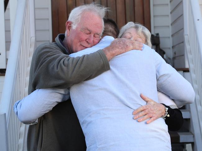 Combat Medic Jonathan Walter hugs Signaller Sean McCarthy’s parents David and Mary at their home in Toowoomba. Sergeant Walter tried valiantly to save Sean’s life on the battlefield in Afghanistan in 2008. Picture: Gary Ramage