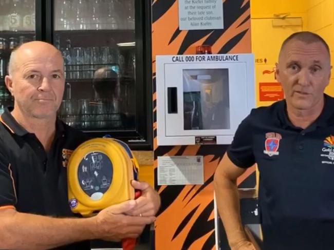 Slacks Creek Football Club President Steve Webb and Scott Whimpey of First Aid Accident and Emergency discuss how a teenage boy was saved using the club's defibrillator machine in this still from a YouTube video. Picture: YouTube