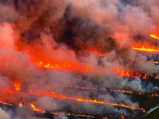 Firefighters are still working to contain the Bribie Island bushfires as the blaze enters its third day. Photo: Ben Mihan