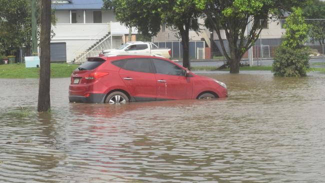 Cars parked at Marie Mackney Courts on Ballina road are inundated by flood water in Lismore for the second time in four weeks Picture: Nicholas Rupolo.