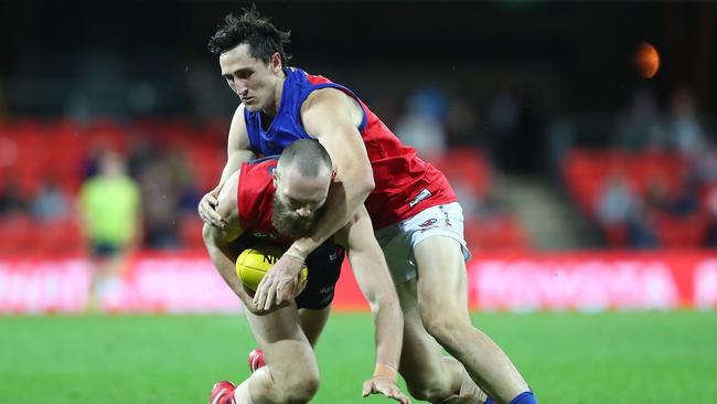 The Demons’ Max Gawn can’t evade the grasp of Brisbane ruckman Oscar McInerney. Picture: Chris Hyde/Getty Images