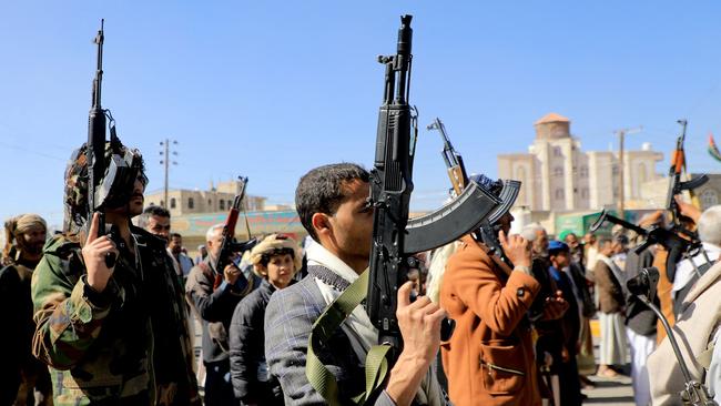 Houthi fighters brandish their weapons during a march in solidarity with the Palestinian people in the Houthi-controlled capital Sanaa on Thursday. Picture: Mohammed Huwais / AFP.