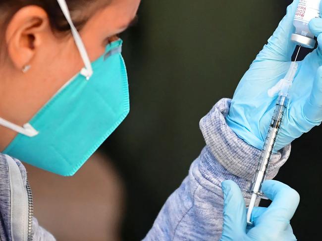 The Moderna Covid-19 vaccine is loaded into a syringe ahead of use on eligible people identified by homeless service agencies from the parking lot of the L.A. Mission on February 24, 2021 in Los Angeles, California. (Photo by Frederic J. BROWN / AFP)