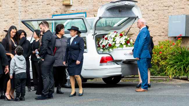 The white coffin was adorned with red roses and white flowers. Picture: NCA NewsWire / Monique Harmer