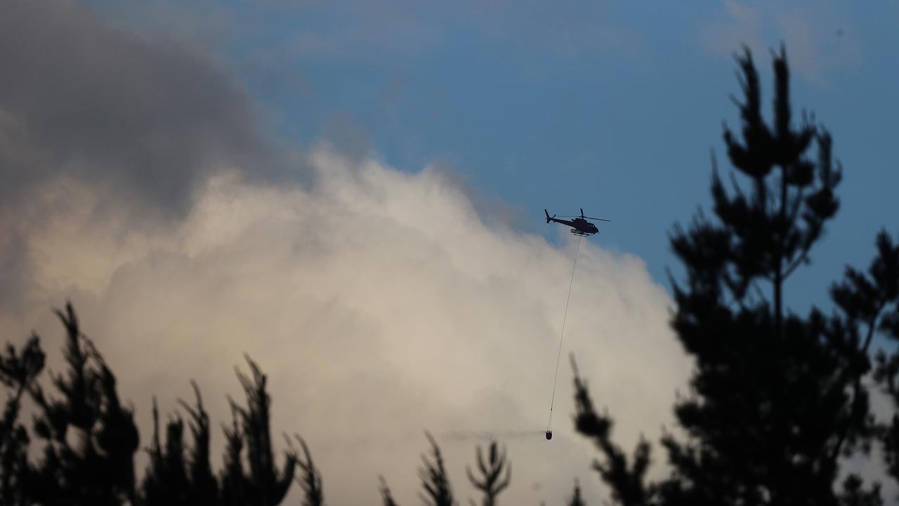 Lachlan Fire: Tasmania Fire Service personnel at Lachlan Fire Station. Helicopter fire fighting asset picks up water near Lachlan. Picture: LUKE BOWDEN