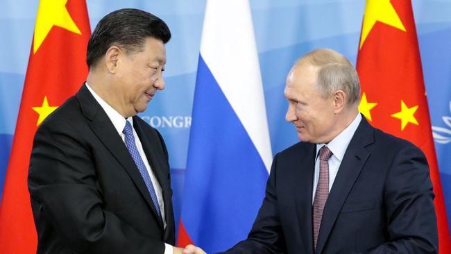 Russia's President Vladimir Putin (R) shakes hands with his Chinese counterpart Xi Jinping. Picture: Sergei Chirikov / POOL / AFP