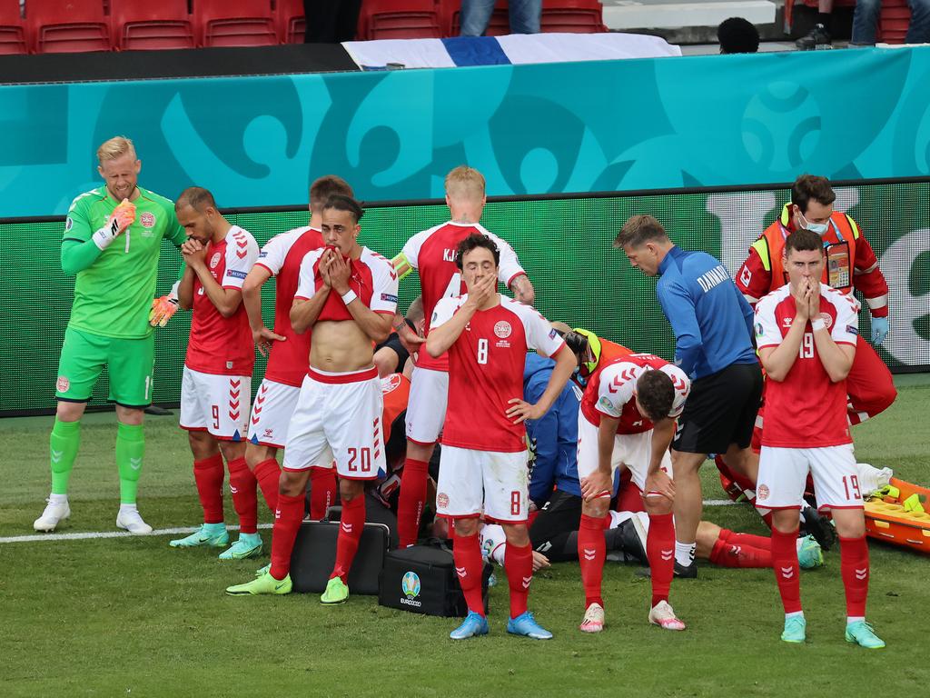 Denmark’s players form a shield.