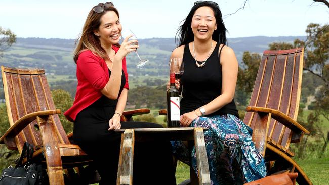 Kristina Parker, 32 and Bonnie Lai, 32, from Hong Kong, seem to agree with Lonely Planet, seen at d'Arenberg Winery in McLaren Vale. Picture Simon Cross