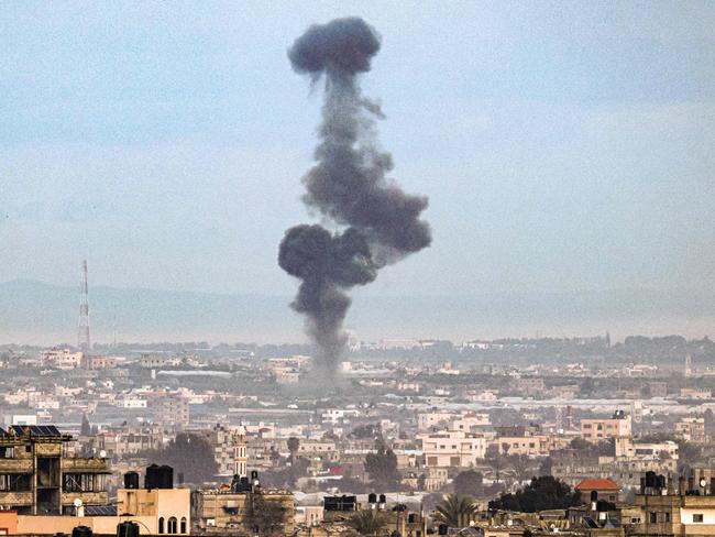 A picture taken from Rafah in the southern Gaza Strip shows smoke rising over buildings in Khan Yunis during Israeli bombardment. Picture” Said Khatib/AFP