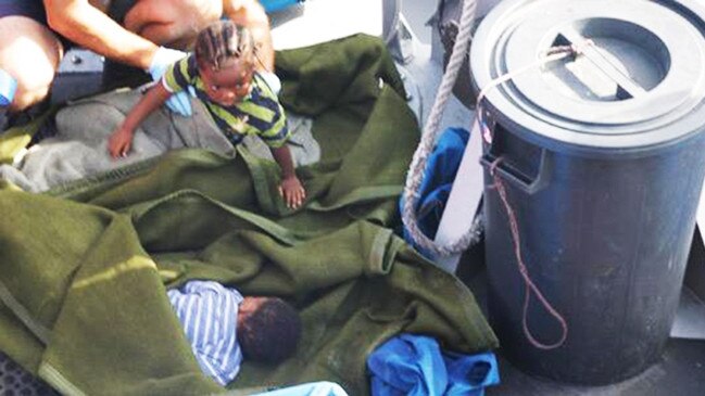 2008 image of Victoria Belando Nicholson (face down blue and white shirt), with sister Destiny in the green and blue stripes. The two infants on board the Armed Forces of Malta patrol boat after being airlifted from the sea. Photo: Crew P 52/AFM Maritime Squadron