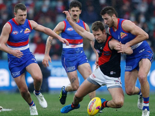 Jake Stringer battles Bulldogs Jack Macrae and Marcus Bontempelli.