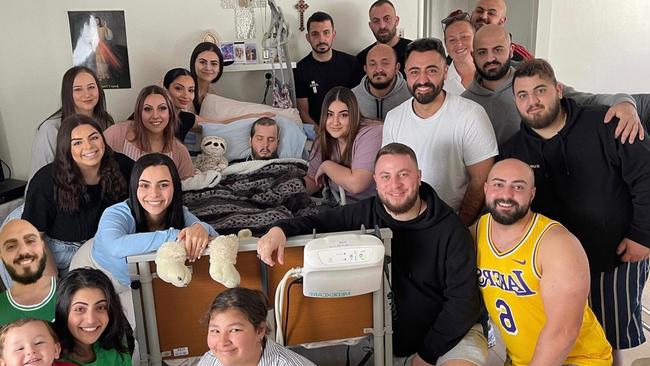 Joseph Tahan surrounded by his family in hospital. Picture: Supplied