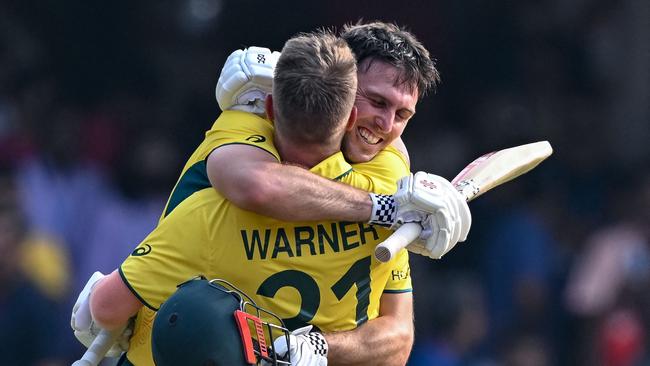 Mitch Marsh celebrates his century with David Warner earlier in the tournament. Picture: Sajjad Hussain.