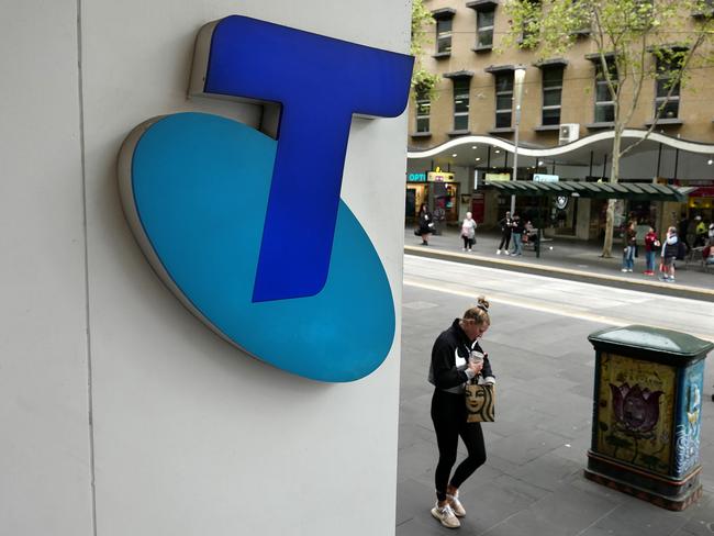 MELBOURNE, AUSTRALIA - NewsWire Photos OCTOBER 4, 2022. Generic photo people walking past the Telstra logo in Melbourne..Picture: NCA NewsWire / Luis Enrique Ascui