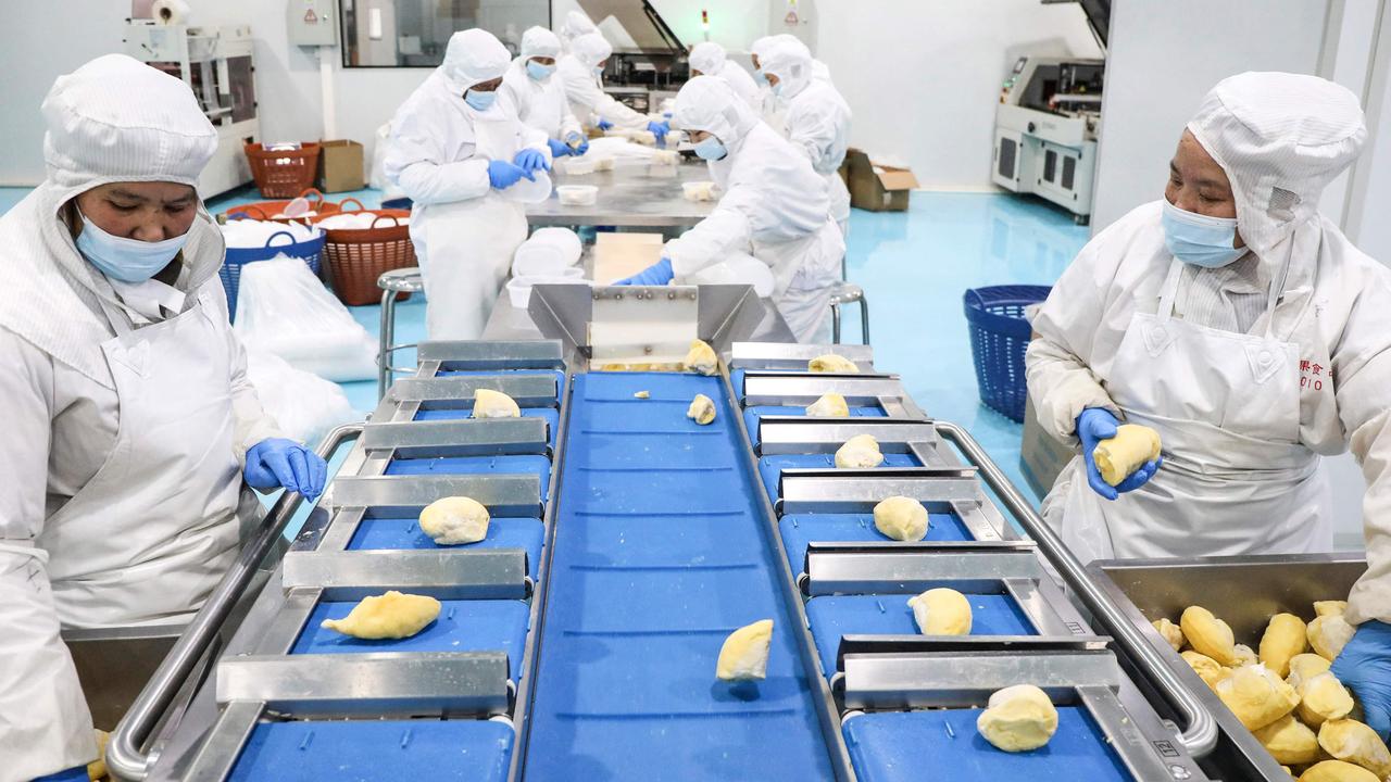 Workers package frozen durian at a food factory in Hangzhou, in China’s eastern Zhejiang province. Picture: AFP