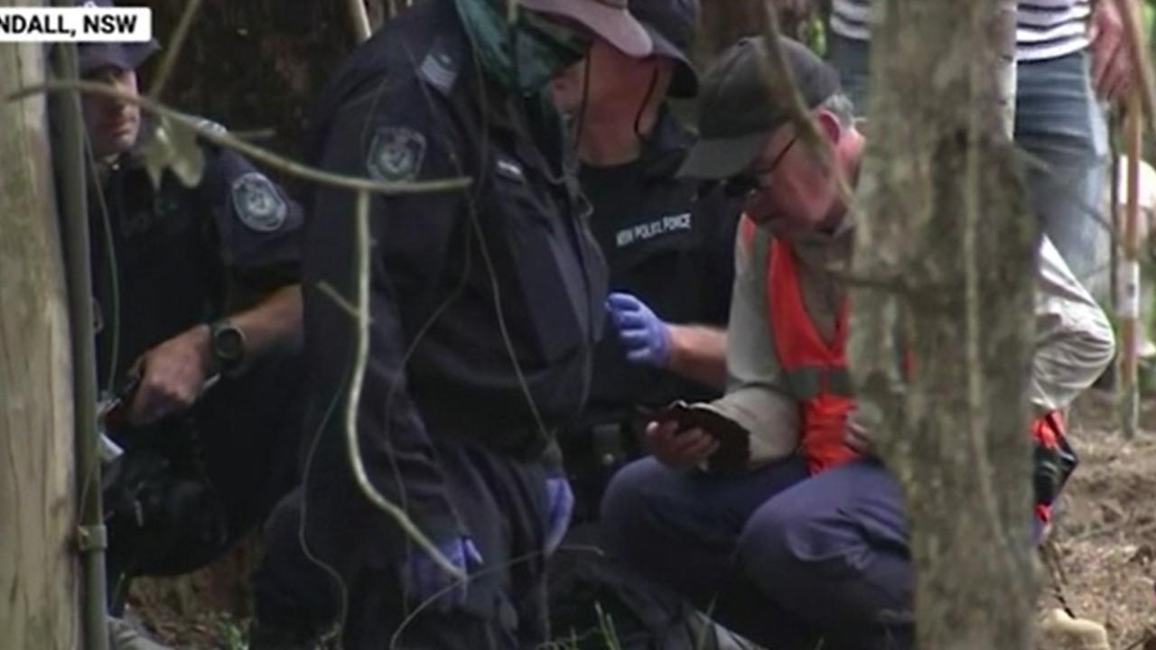 NSW Police examining an object in bushland on Wednesday. Picture: Sky News