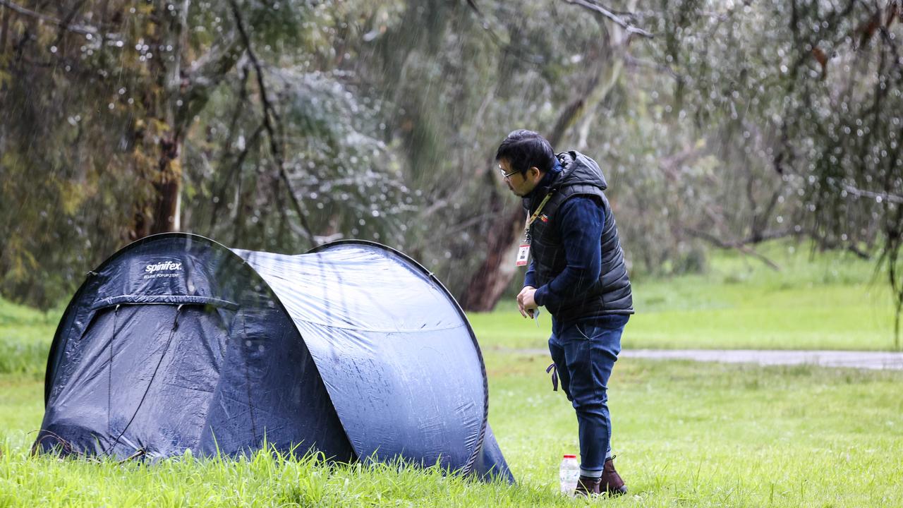 Case Manager Trung Cao near a tent in the West Parkland during Code Blue Outreach early morning checks. Picture: Russell Millard